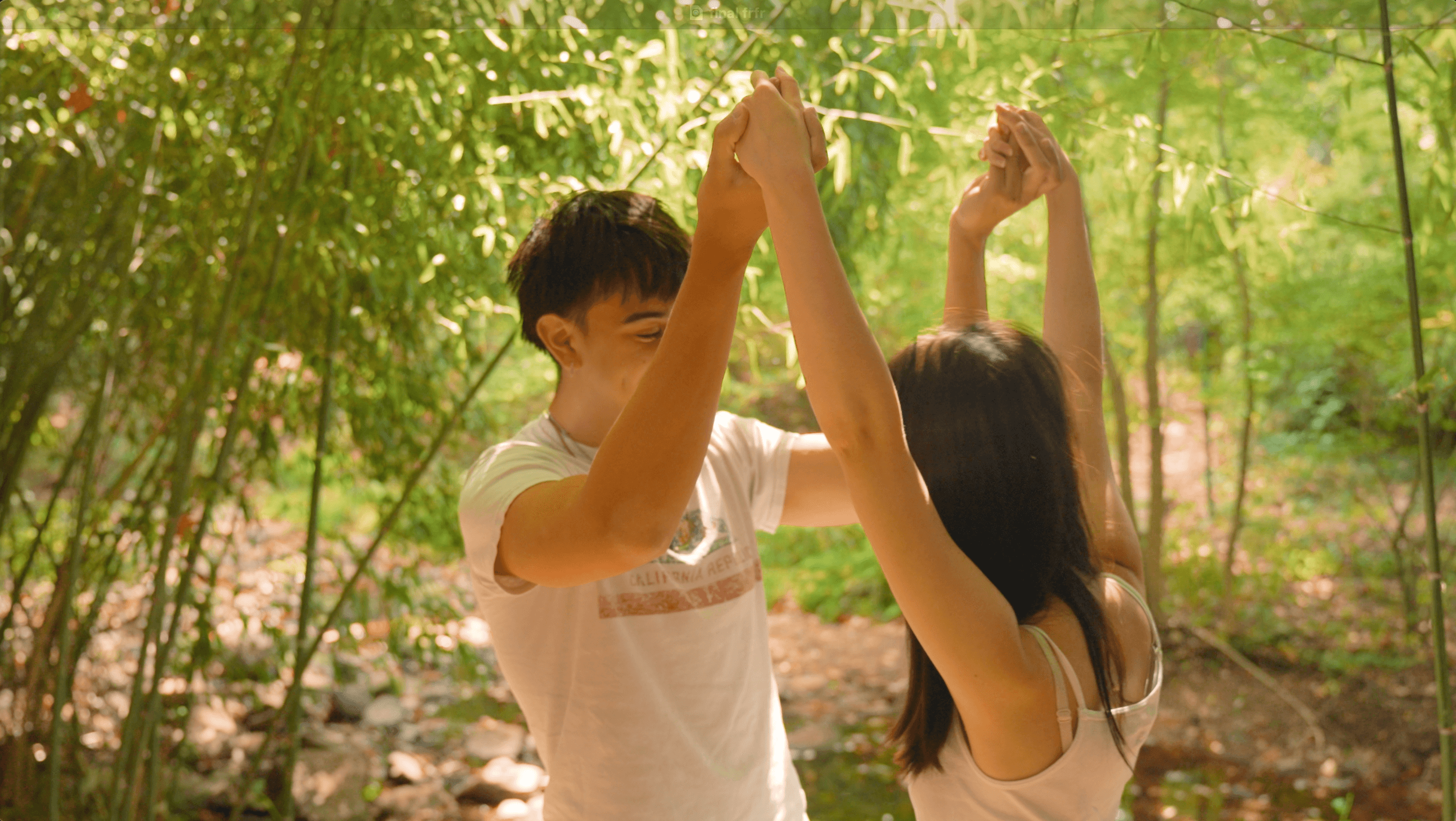 Guy and girl lock hands, laughing